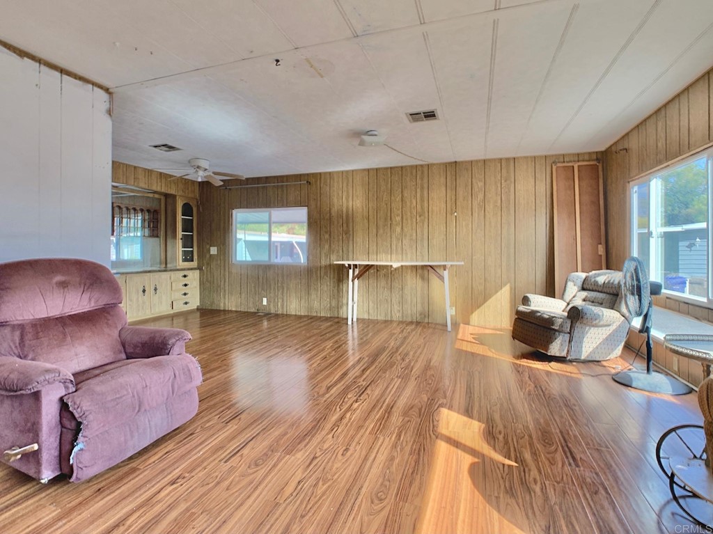 400 Greenfield Drive, Unit 150 El Cajon, CA 92021 - Photo 7 of 21 a living room with furniture and a wooden floor