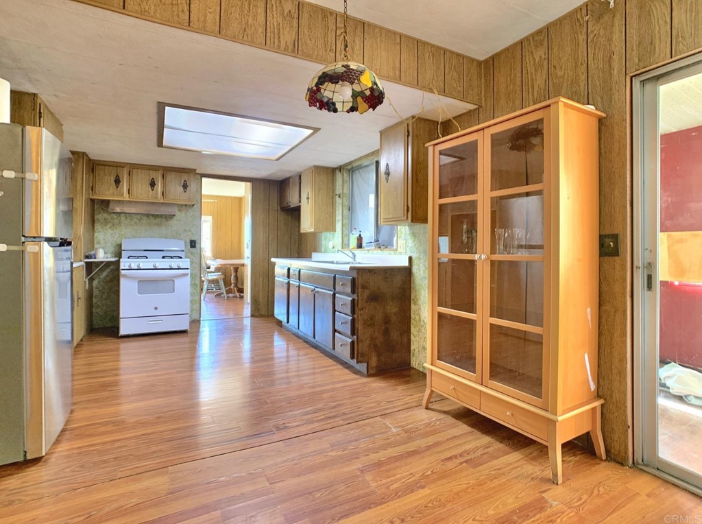 400 Greenfield Drive, Unit 150 El Cajon, CA 92021 - Photo 8 of 21 a view of a kitchen with cabinets and wooden floor