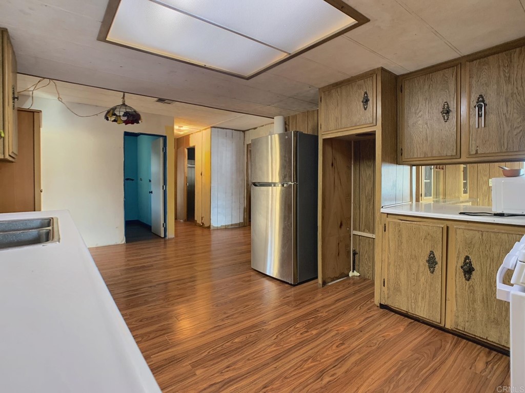 400 Greenfield Drive, Unit 150 El Cajon, CA 92021 - Photo 10 of 21 a view of a hallway with wooden floor and staircase