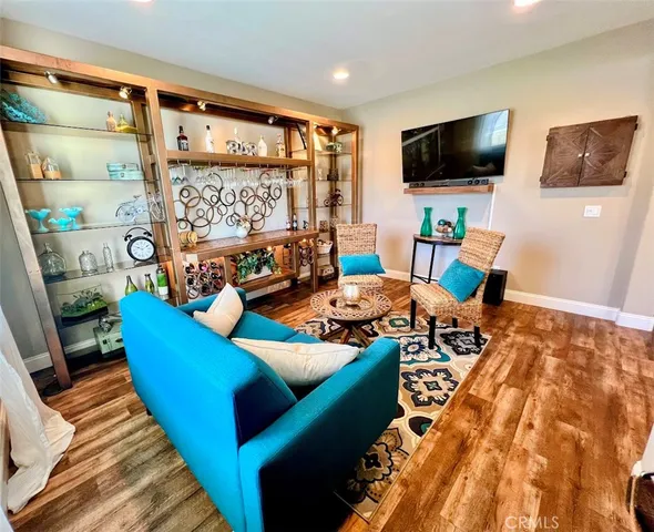 a large kitchen with stainless steel appliances a stove a sink dishwasher and a dining table with the living room view