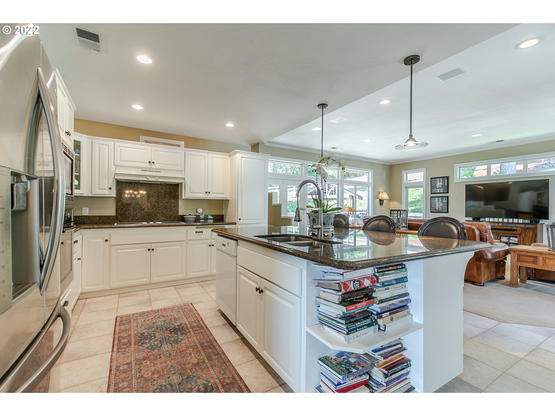 33315 Bloomberg Road Eugene, OR 97405 - Photo 13 of 32 a kitchen with stainless steel appliances granite countertop a sink dishwasher a refrigerator and white cabinets with wooden floor