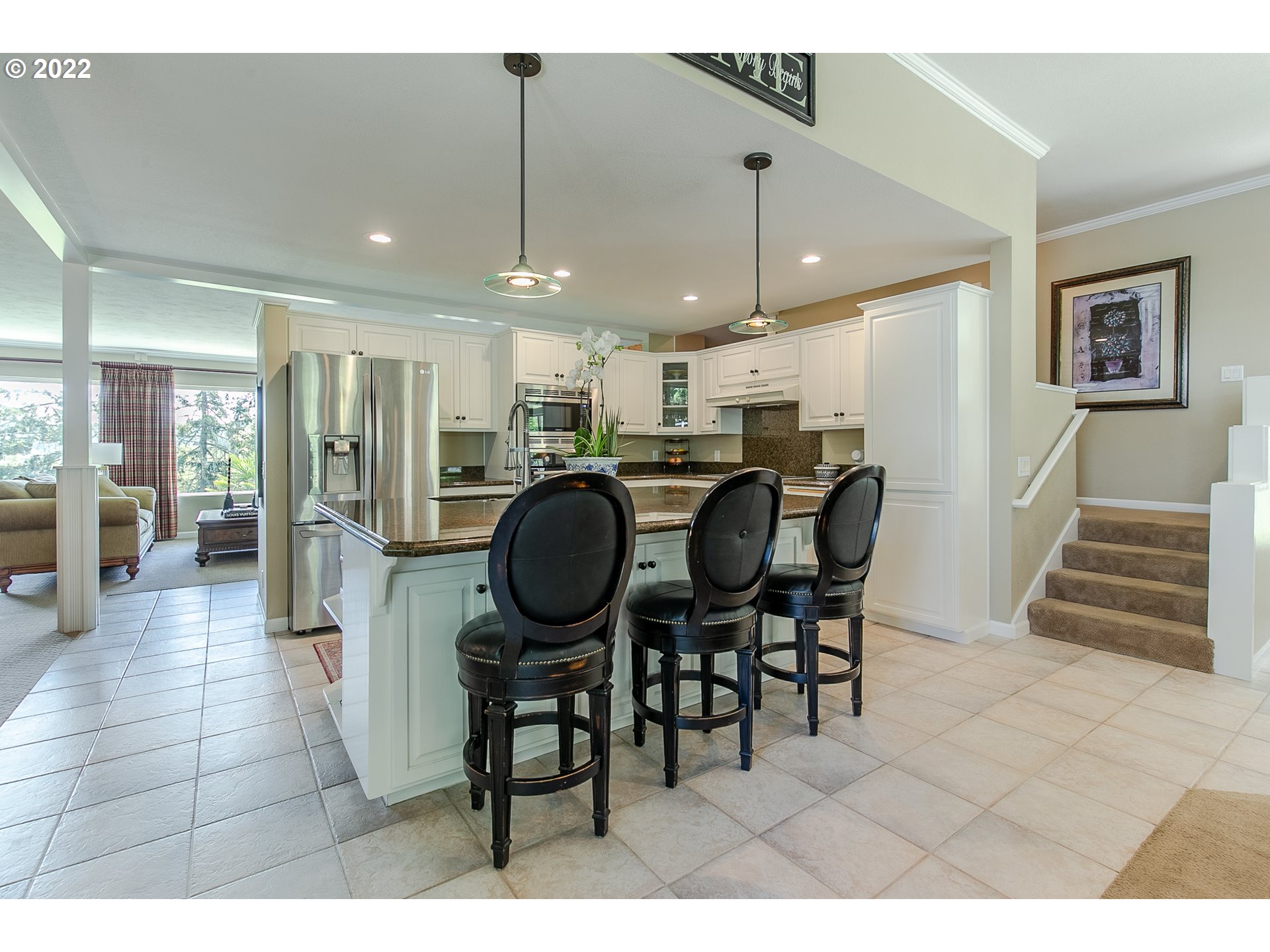33315 Bloomberg Road Eugene, OR 97405 - Photo 15 of 32 a open kitchen with stainless steel appliances kitchen island granite countertop a table chairs and a refrigerator