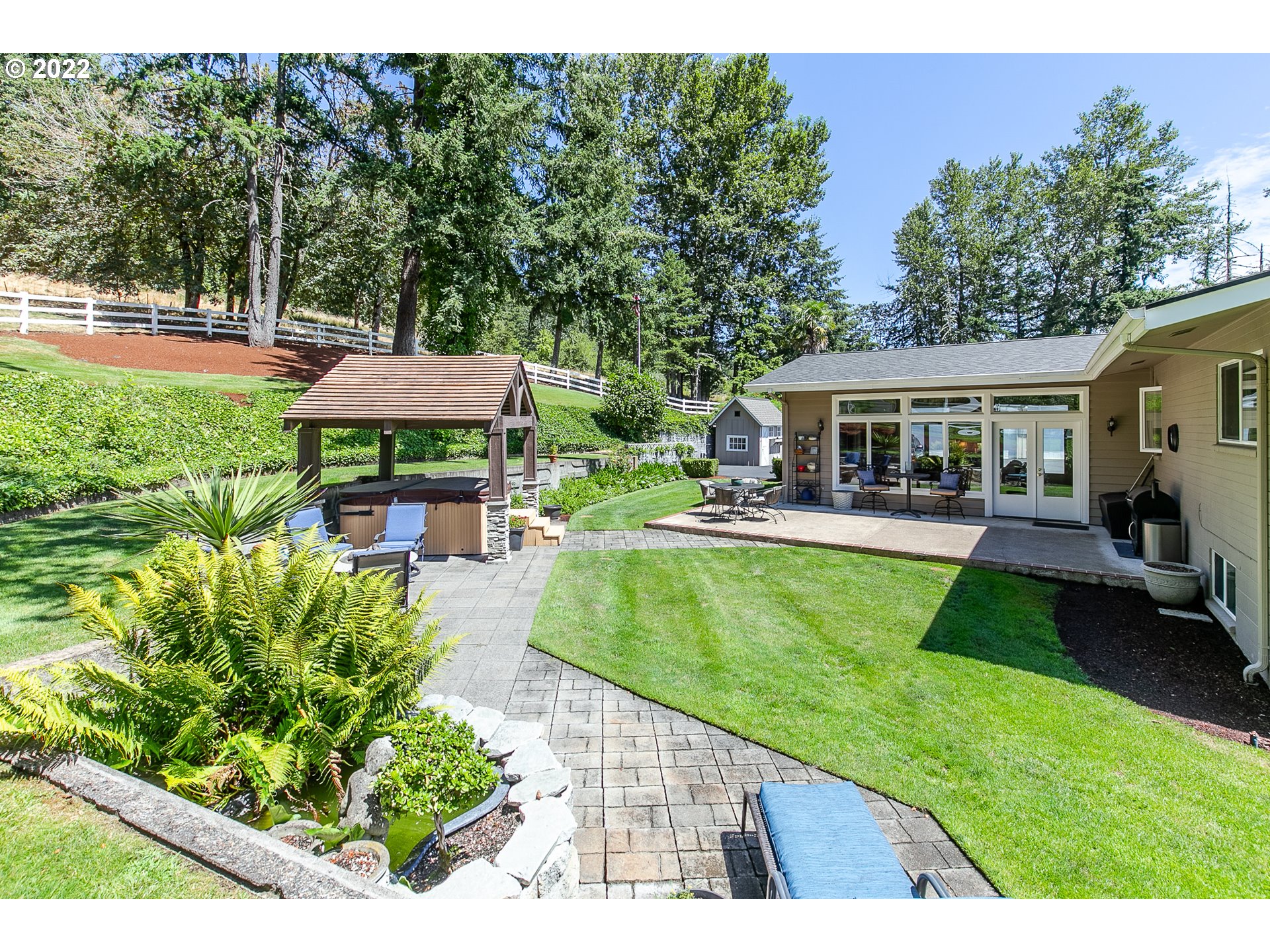 33315 Bloomberg Road Eugene, OR 97405 - Photo 27 of 32 a view of a house with a swimming pool lawn chairs and a yard