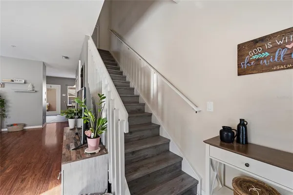 a view of entryway and hall with wooden floor