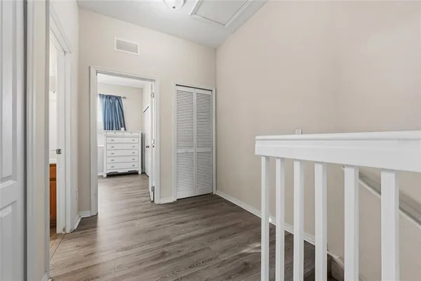 a view of a hallway with wooden floor