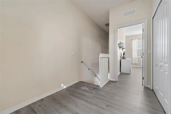 wooden floor in a hall with an empty room