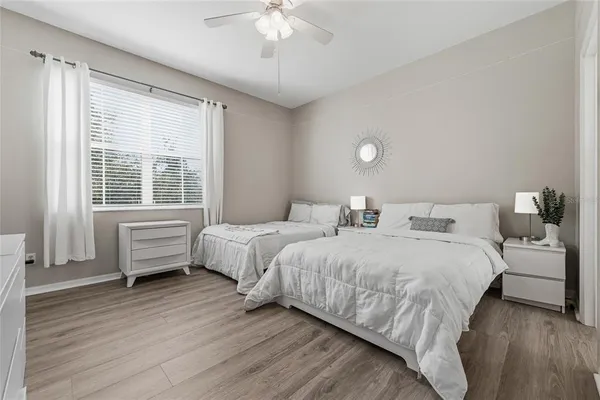 a bedroom with two beds and a chandelier