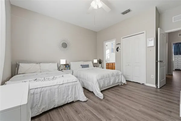 a bedroom with two beds and a chandelier