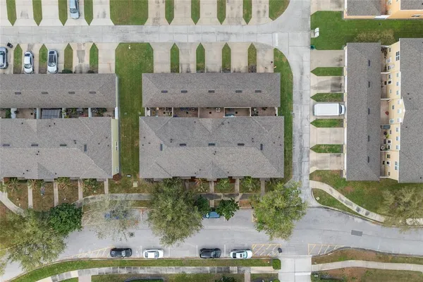 an aerial view of a house with a yard