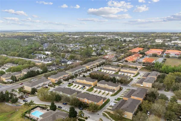 an aerial view of residential building with green space