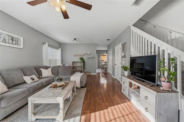 a living room with furniture and a flat screen tv