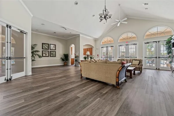 a living room with furniture and a chandelier