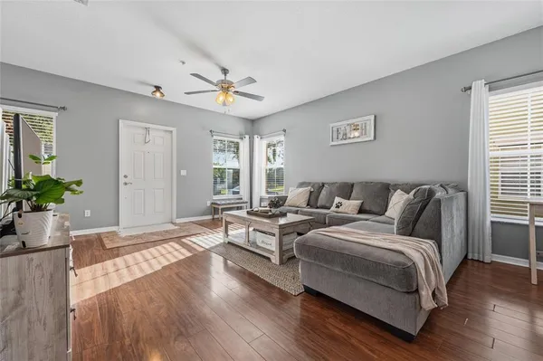 a large bedroom with a bed and wooden floor