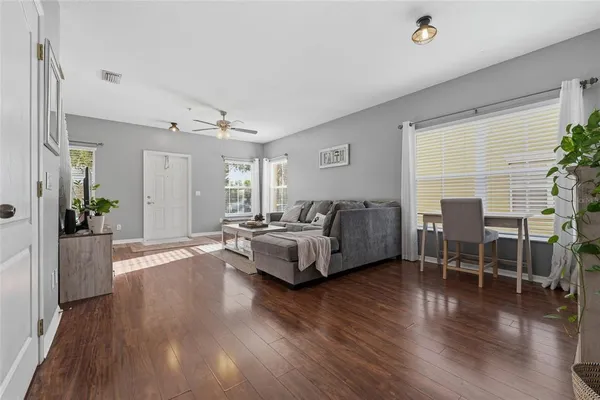 a living room with furniture and wooden floor