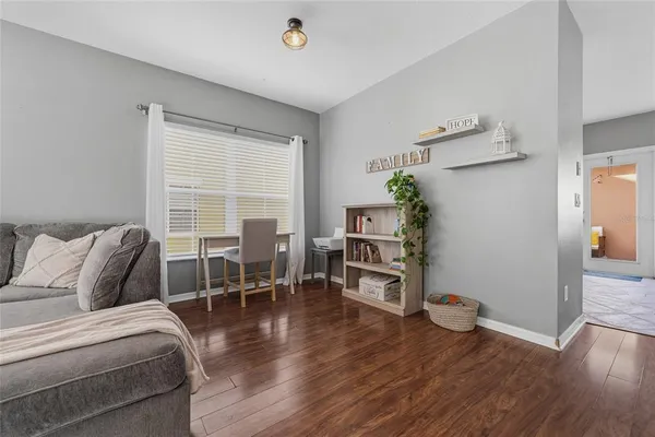 a living room with furniture and wooden floor