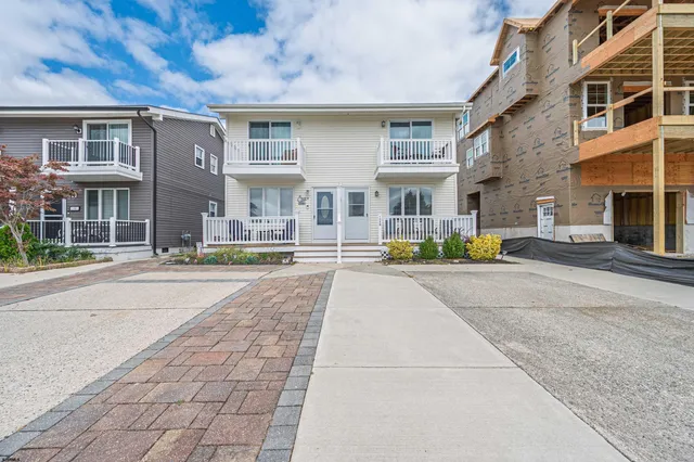 a front view of residential houses with yard