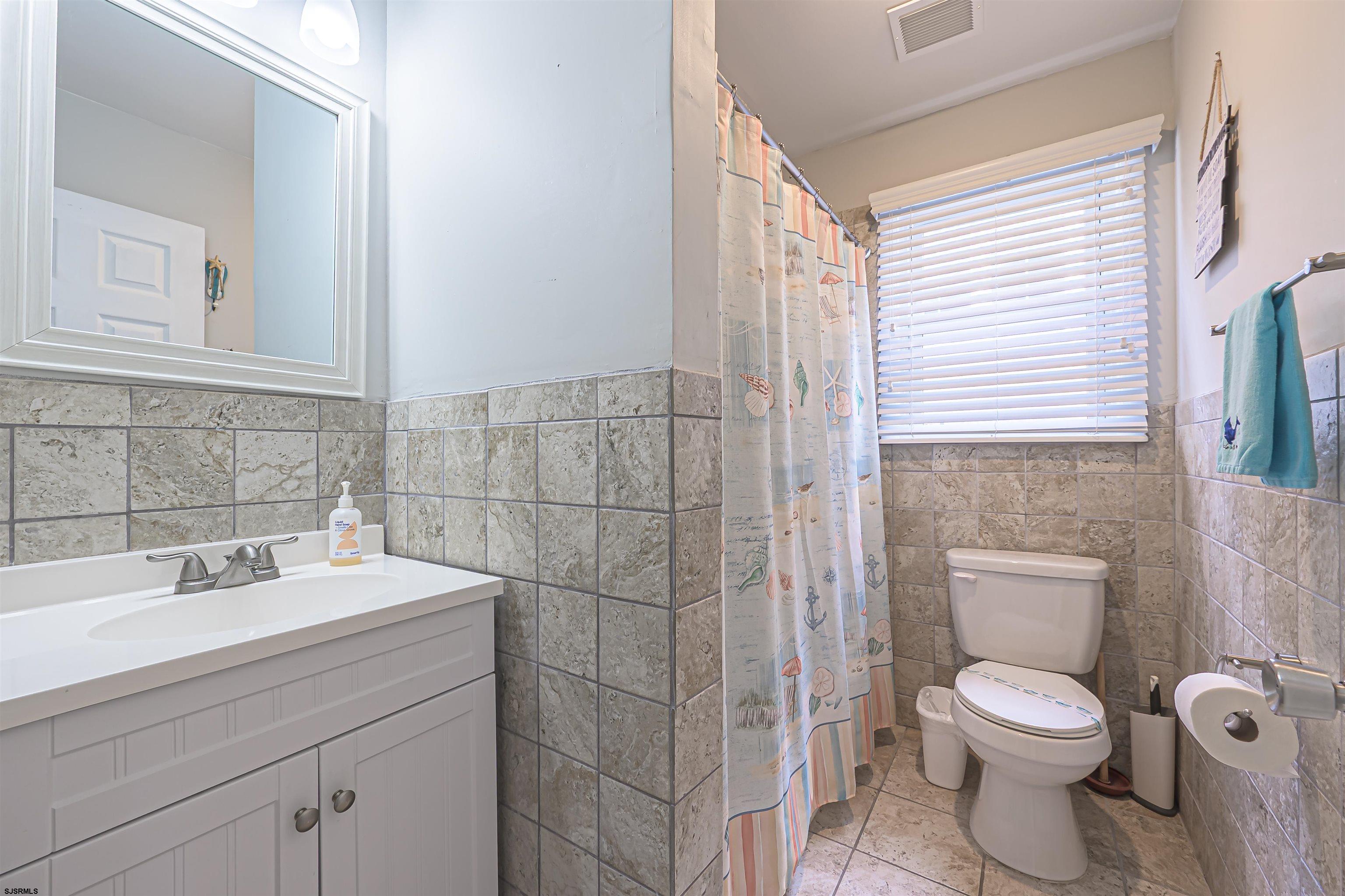 138 44th Street South, Unit D Brigantine, NJ 08203 - Photo 18 of 25 a bathroom with a sink a toilet and shower