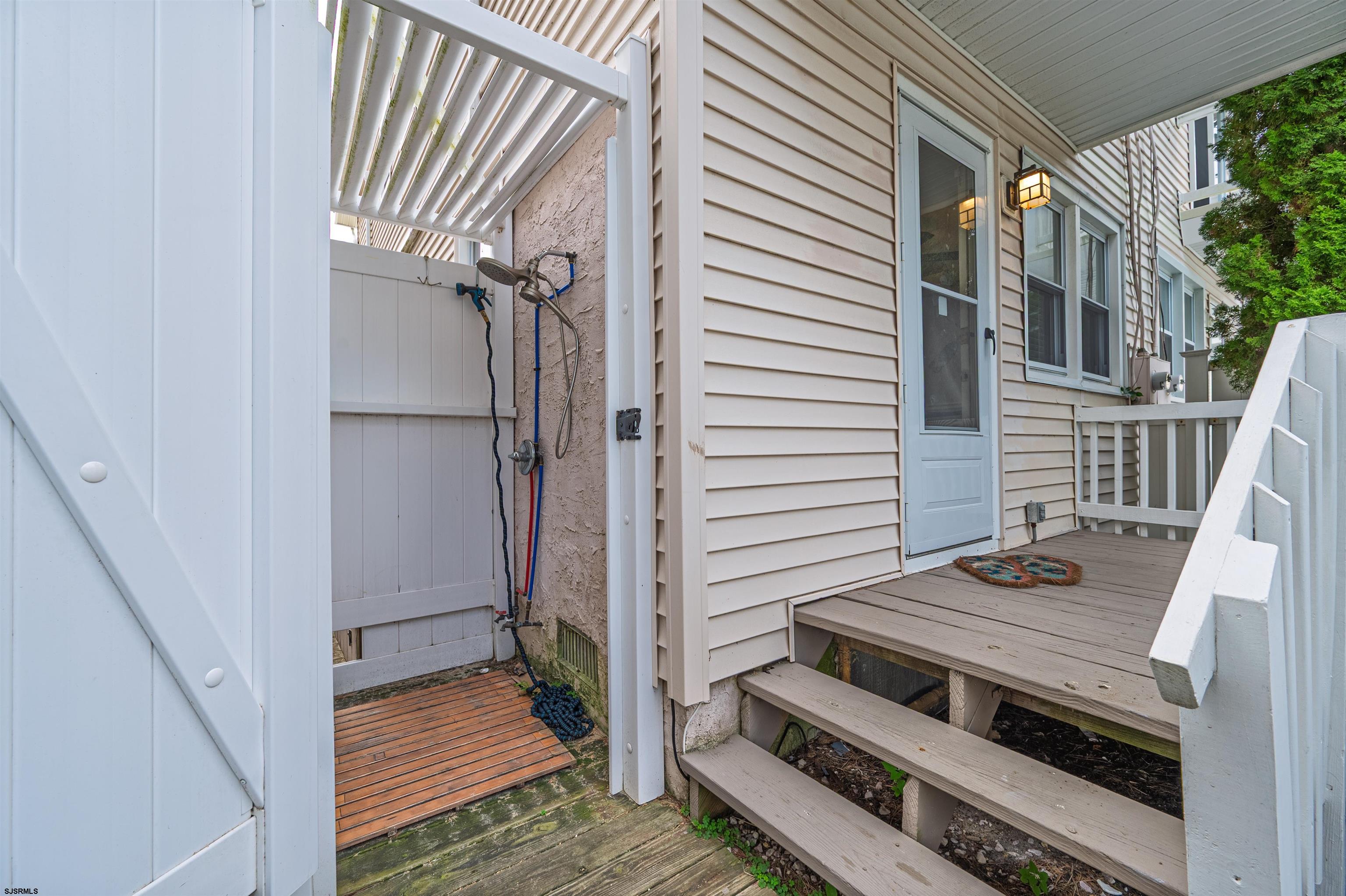 138 44th Street South, Unit D Brigantine, NJ 08203 - Photo 21 of 25 a view of a livingroom with wooden floor and stairs