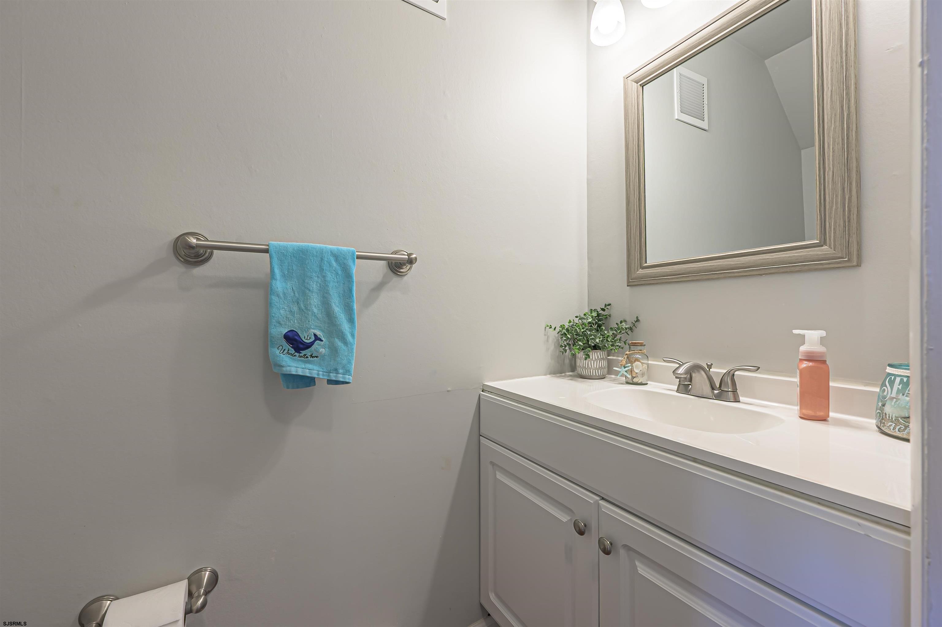 138 44th Street South, Unit D Brigantine, NJ 08203 - Photo 6 of 25 a bathroom with a sink and a mirror
