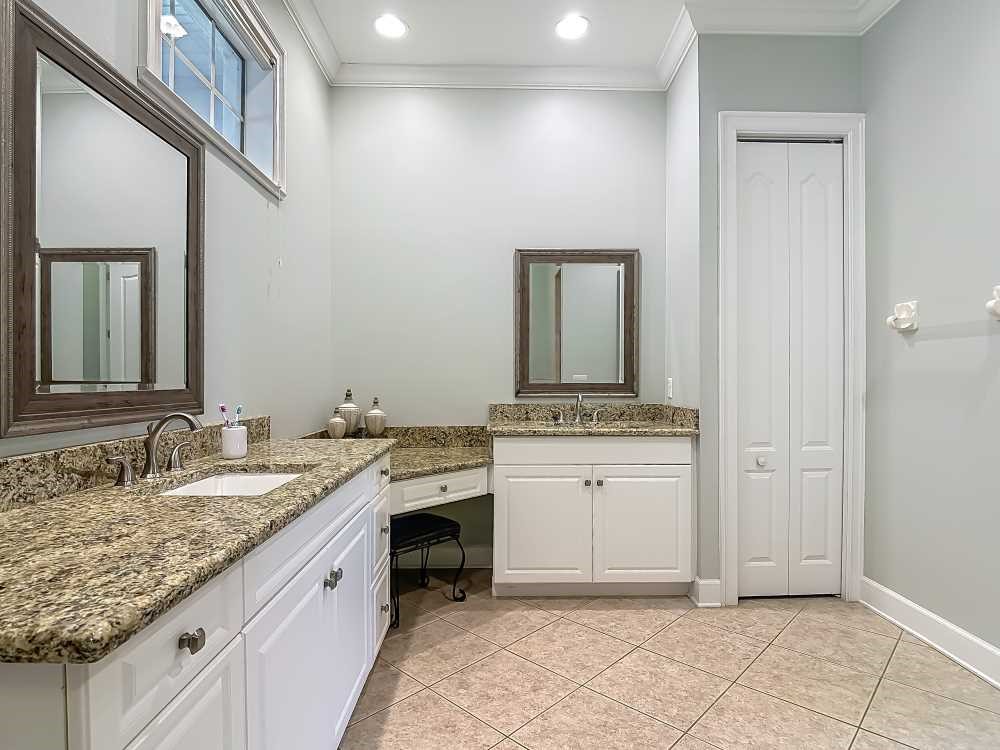 7330 36th Court Vero Beach, FL 32967 - Photo 16 of 33 a spacious bathroom with a granite countertop sink and a mirror