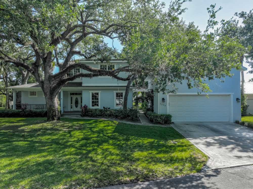 7330 36th Court Vero Beach, FL 32967 - Photo 2 of 33 a front view of a house with a garden