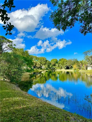 a view of a lake with houses in the back