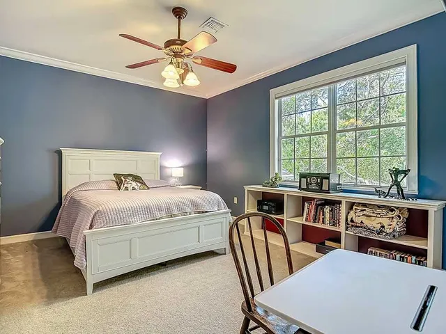 a bedroom with a bed and a large window