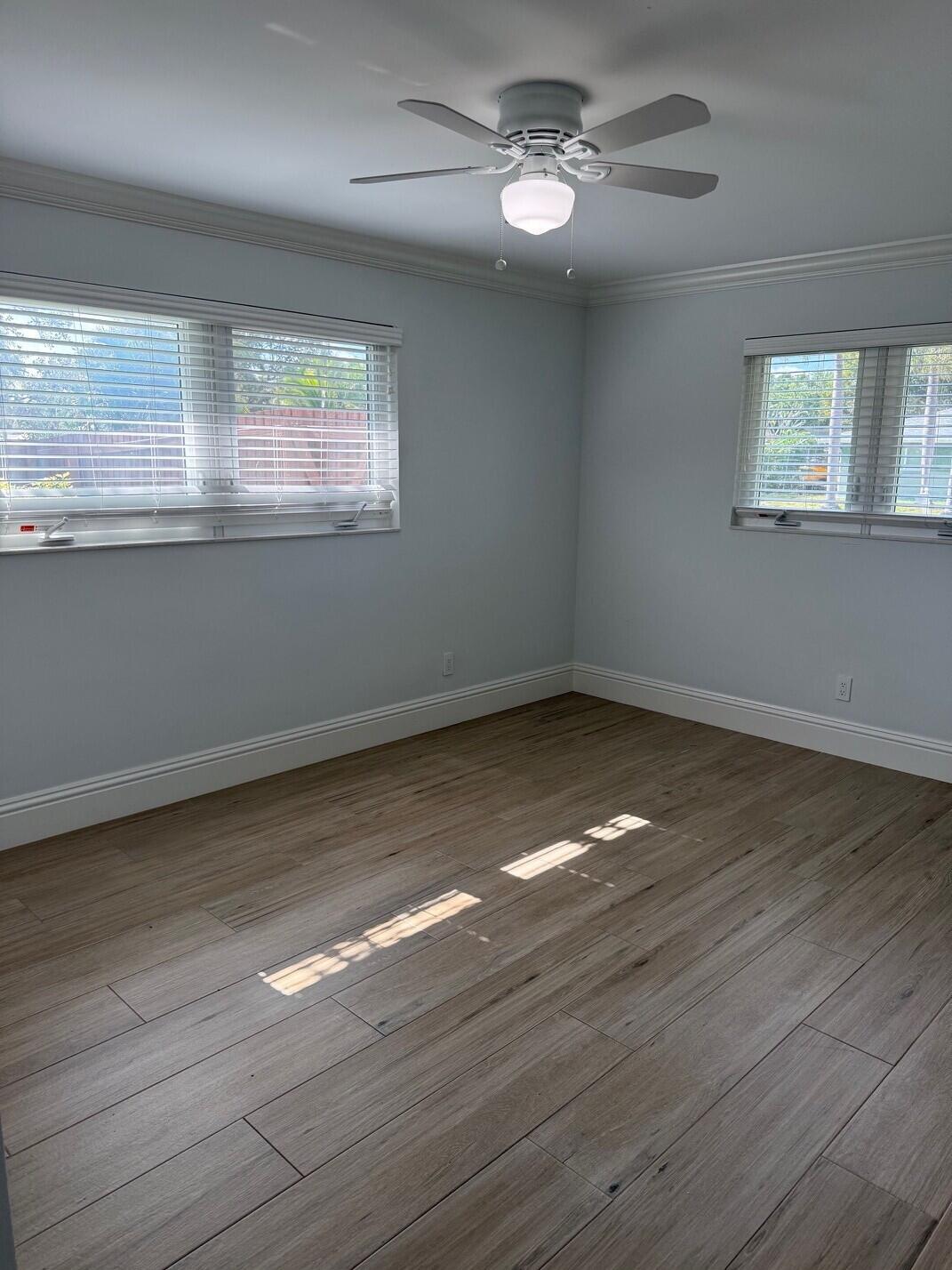 1611 Treemont Avenue Jupiter, FL 33469 - Photo 21 of 28 a view of empty room with wooden floor and fan