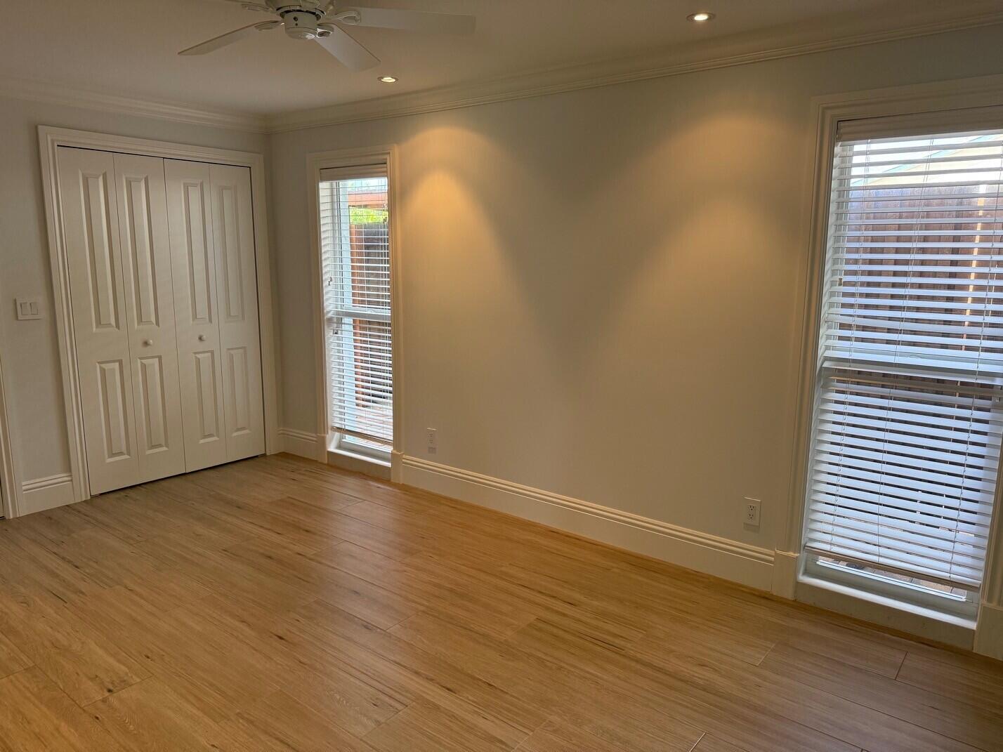 1611 Treemont Avenue Jupiter, FL 33469 - Photo 8 of 28 a view of an empty room with wooden floor and a window