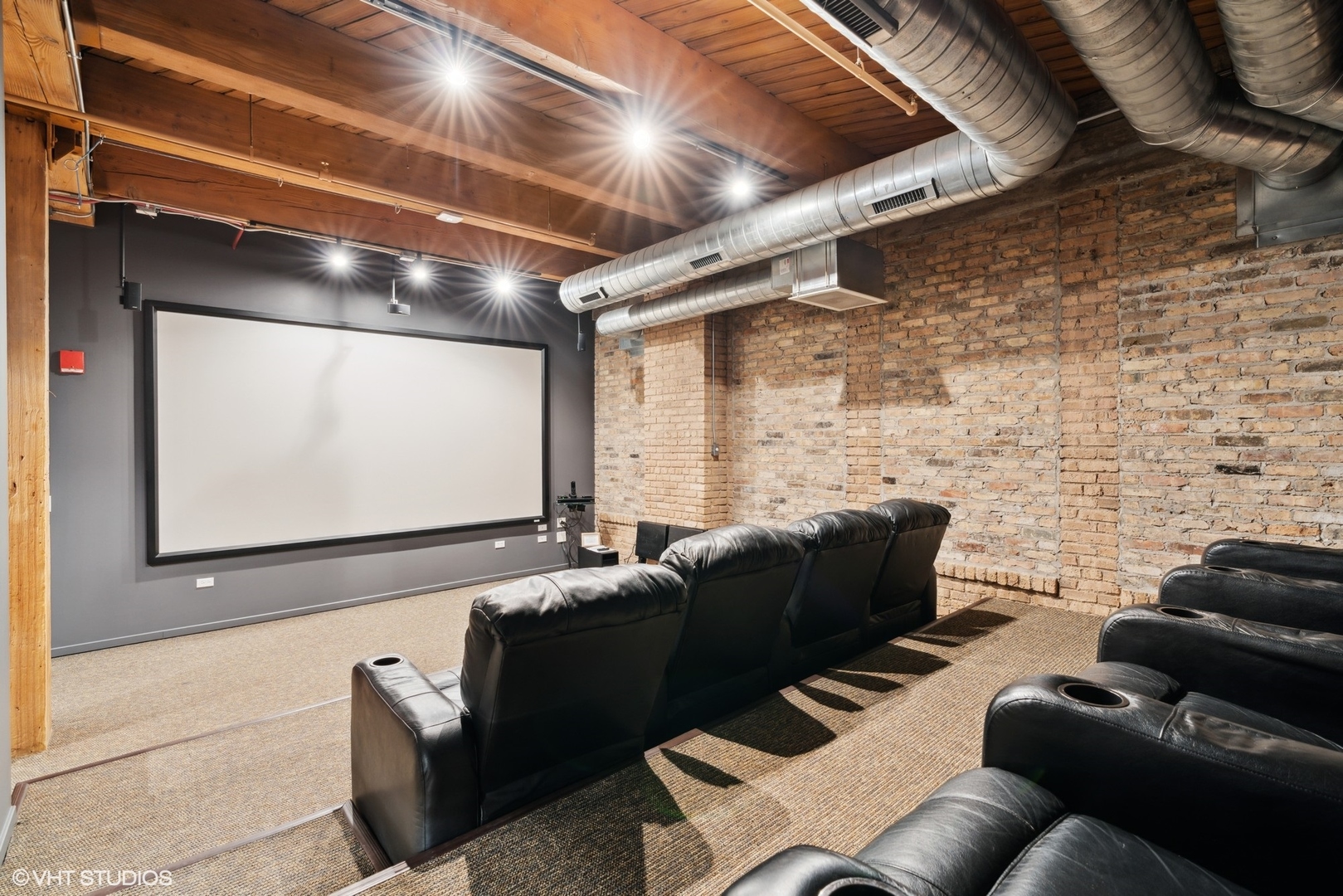 1040 West Adams Street, Unit 107 Chicago, IL 60607 - Photo 12 of 14 a living room with furniture and a flat screen tv