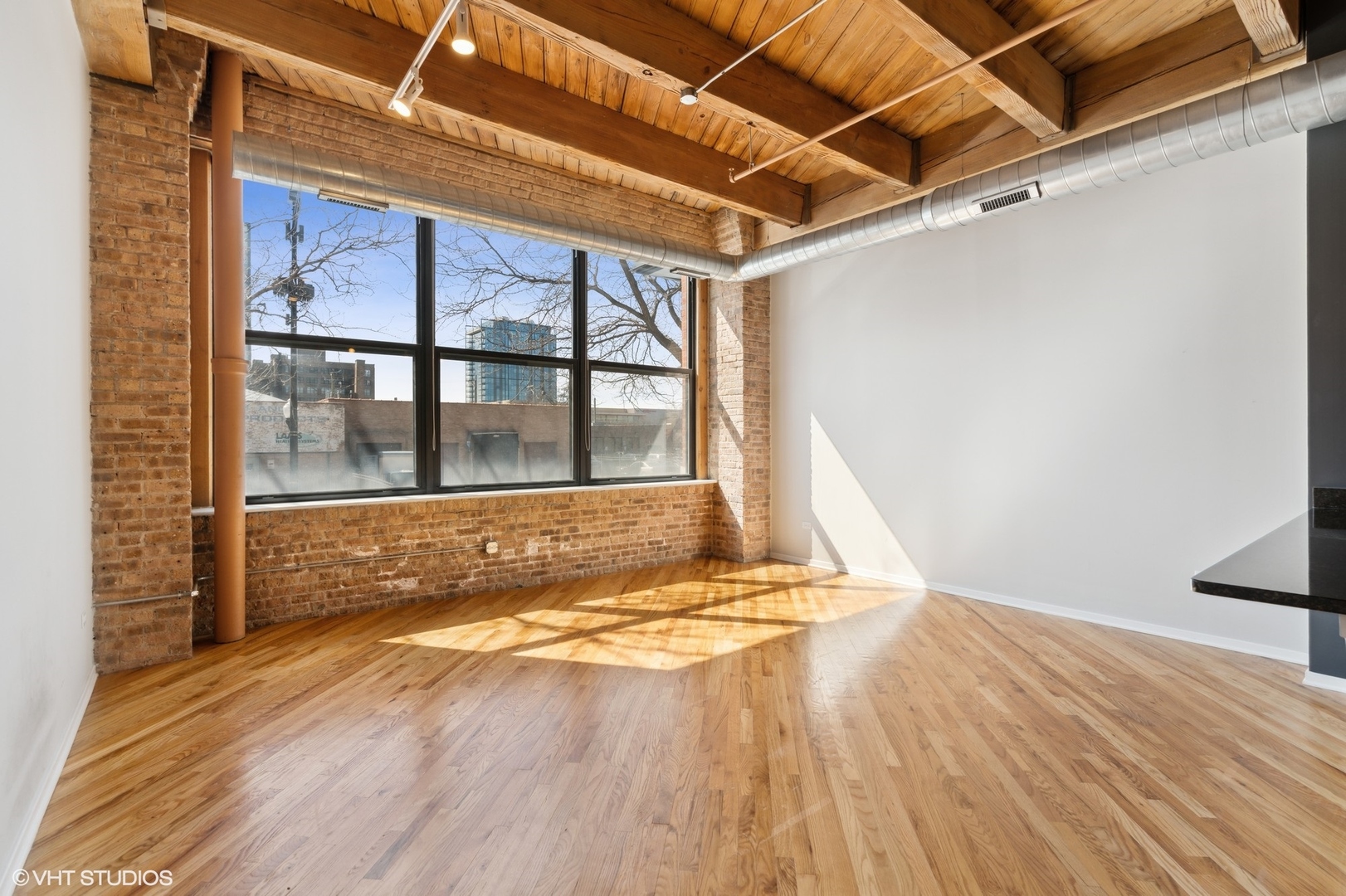 1040 West Adams Street, Unit 107 Chicago, IL 60607 - Photo 4 of 14 a view of walk in closet with wooden floor