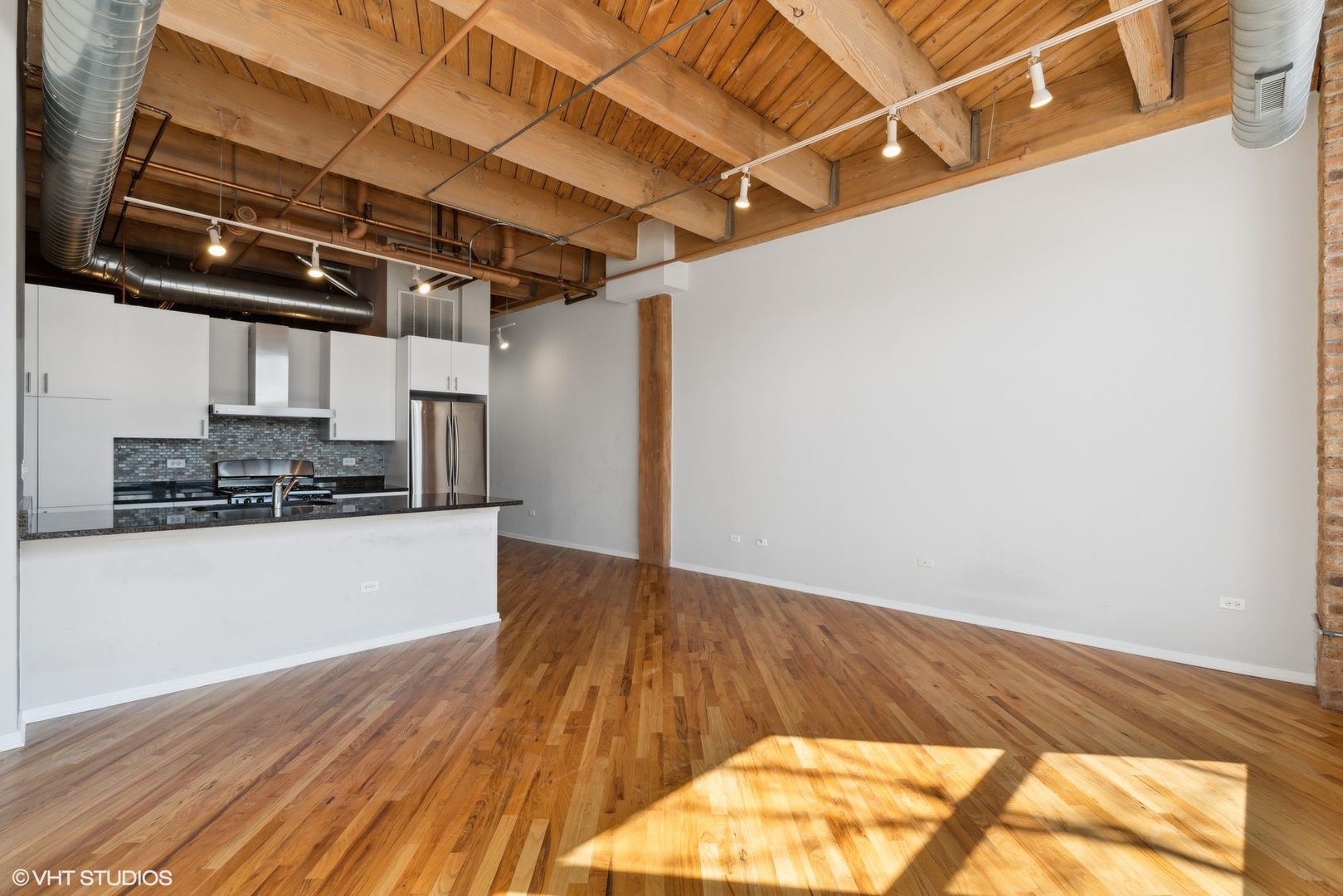 1040 West Adams Street, Unit 107 Chicago, IL 60607 - Photo 5 of 14 a view of kitchen with wooden floor