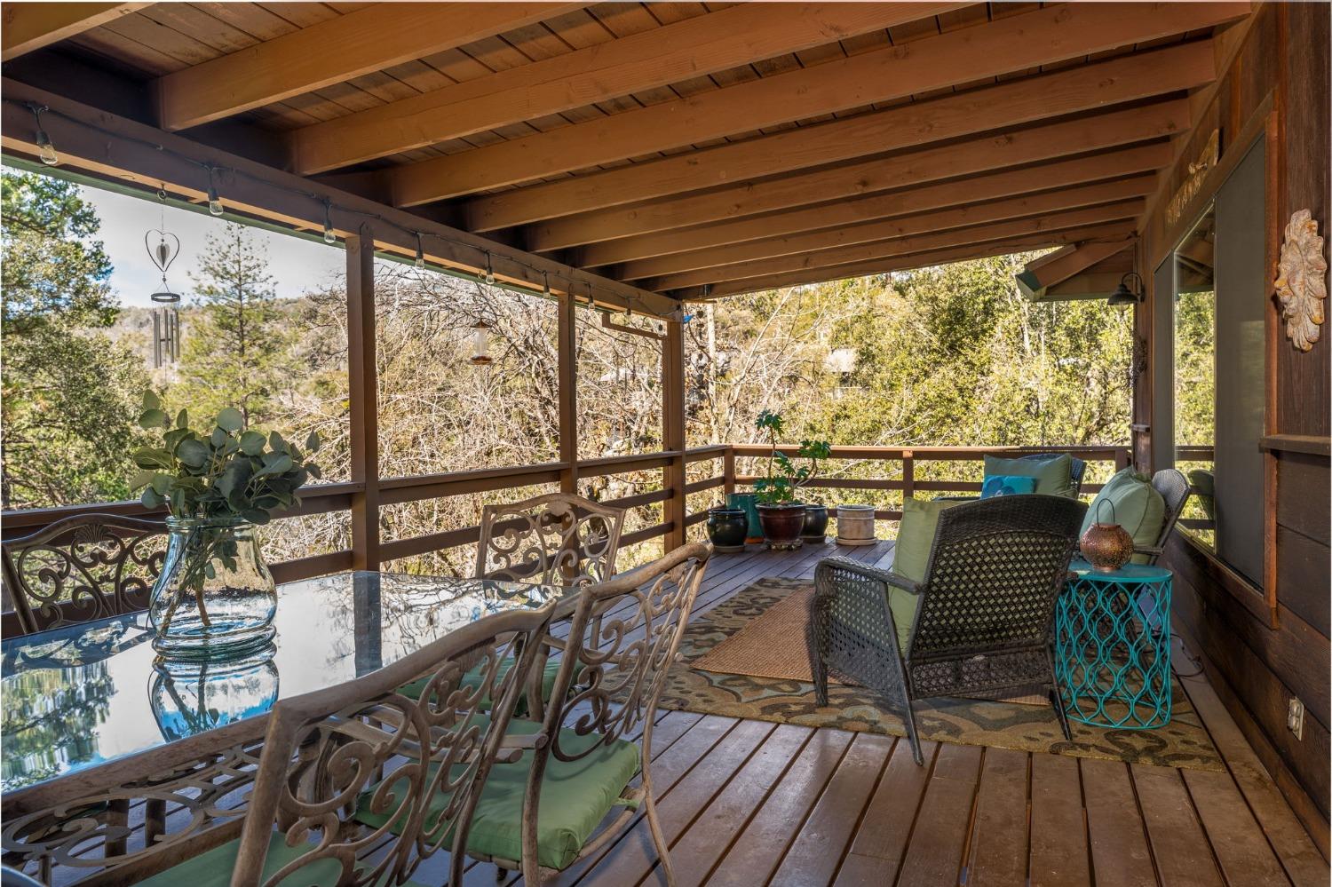 42538 Buckeye Road Oakhurst, CA 93644 - Photo 12 of 46 a view of a chairs and table in patio with wooden floor