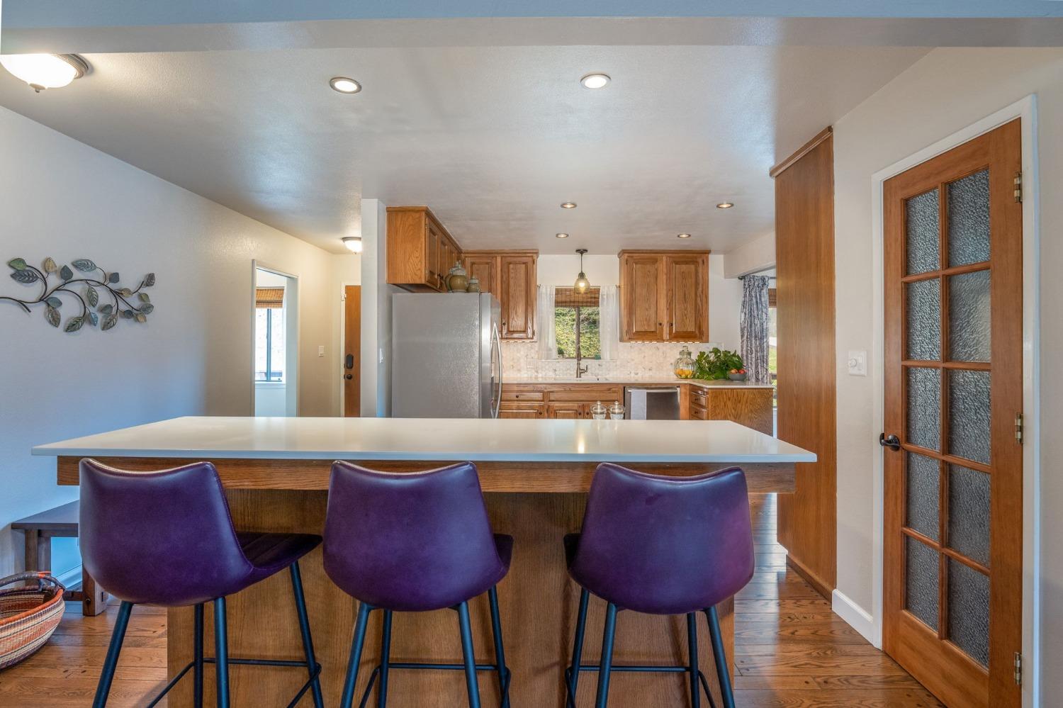 42538 Buckeye Road Oakhurst, CA 93644 - Photo 17 of 46 a view of a dining room with furniture and wooden floor