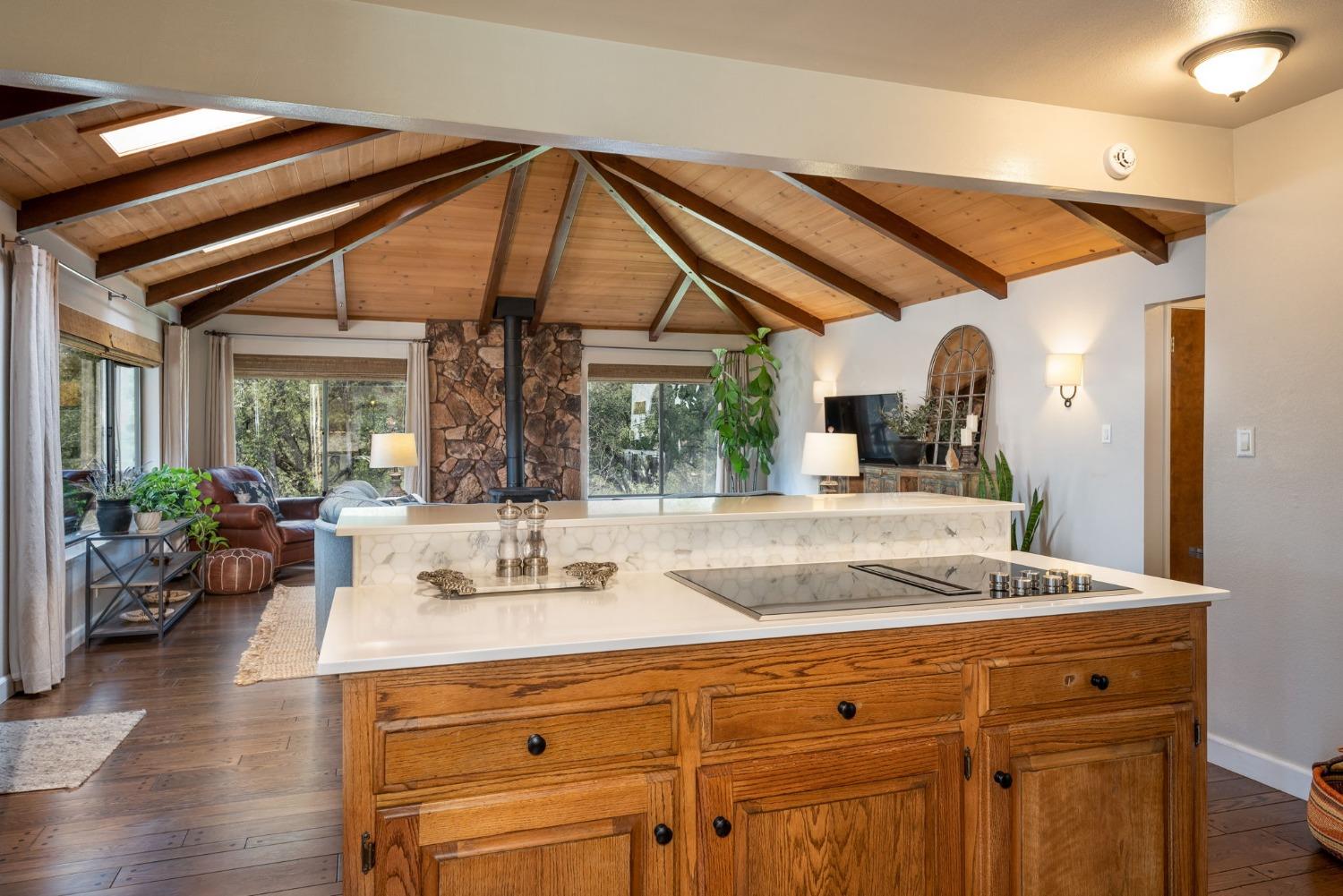 42538 Buckeye Road Oakhurst, CA 93644 - Photo 18 of 46 a room with kitchen island a large window and furniture