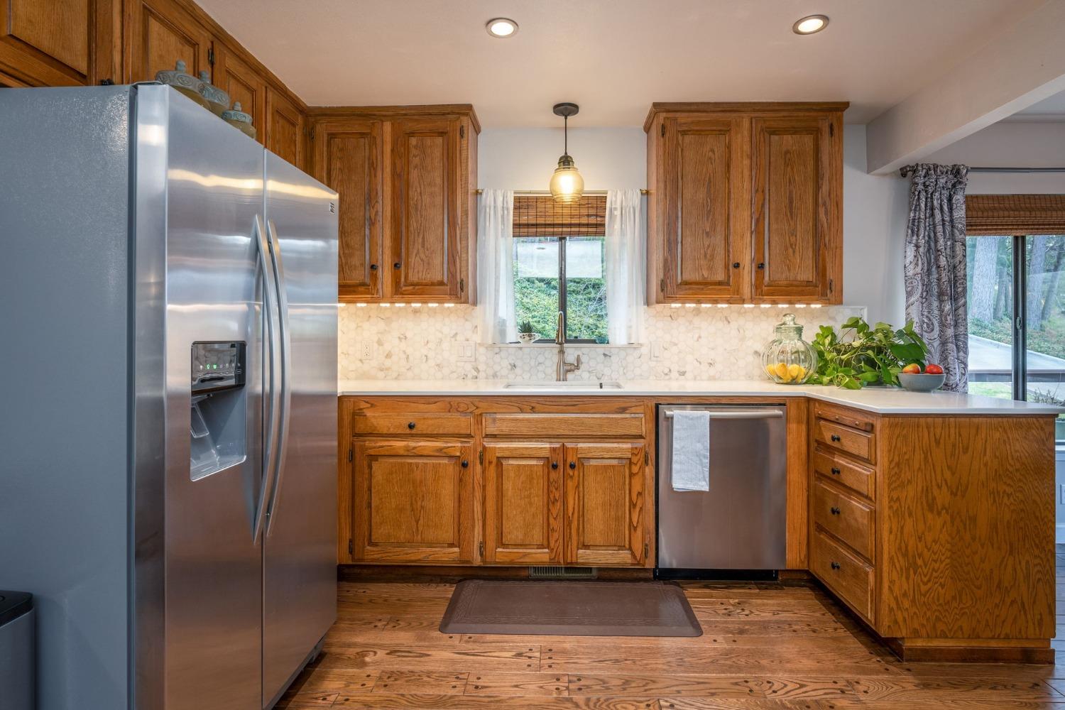 42538 Buckeye Road Oakhurst, CA 93644 - Photo 19 of 46 a kitchen with stainless steel appliances granite countertop a refrigerator and a sink