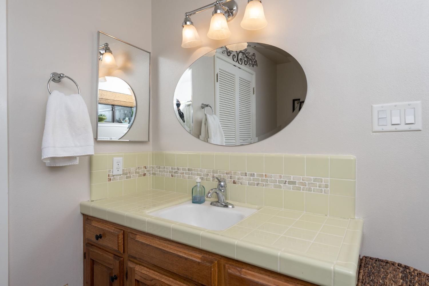 42538 Buckeye Road Oakhurst, CA 93644 - Photo 29 of 46 a bathroom with a sink and a mirror