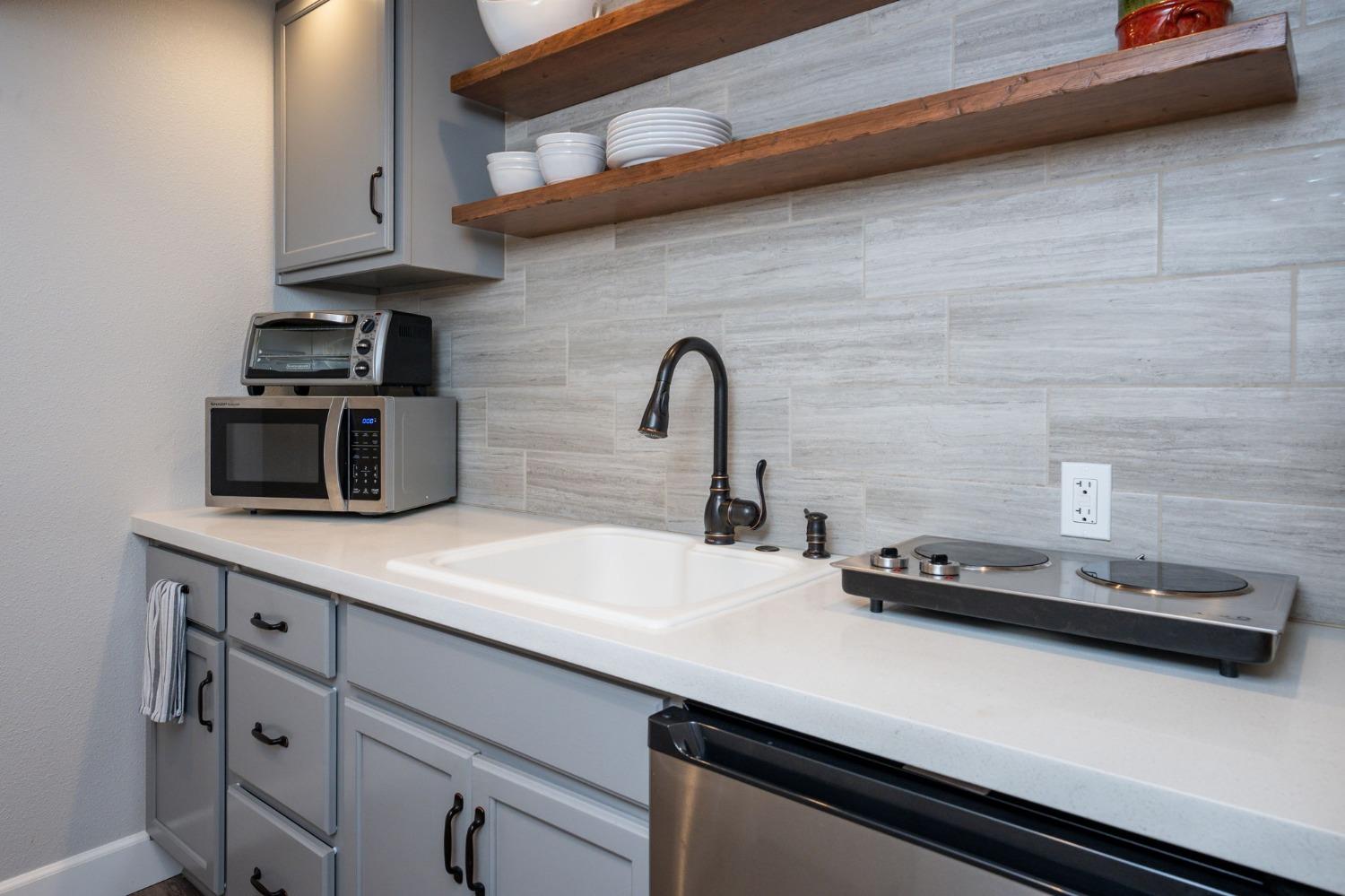 42538 Buckeye Road Oakhurst, CA 93644 - Photo 32 of 46 a kitchen with stainless steel appliances a sink dishwasher stove and cabinets