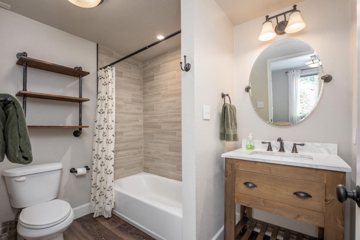 42538 Buckeye Road Oakhurst, CA 93644 - Photo 33 of 46 a bathroom with a sink toilet and shower