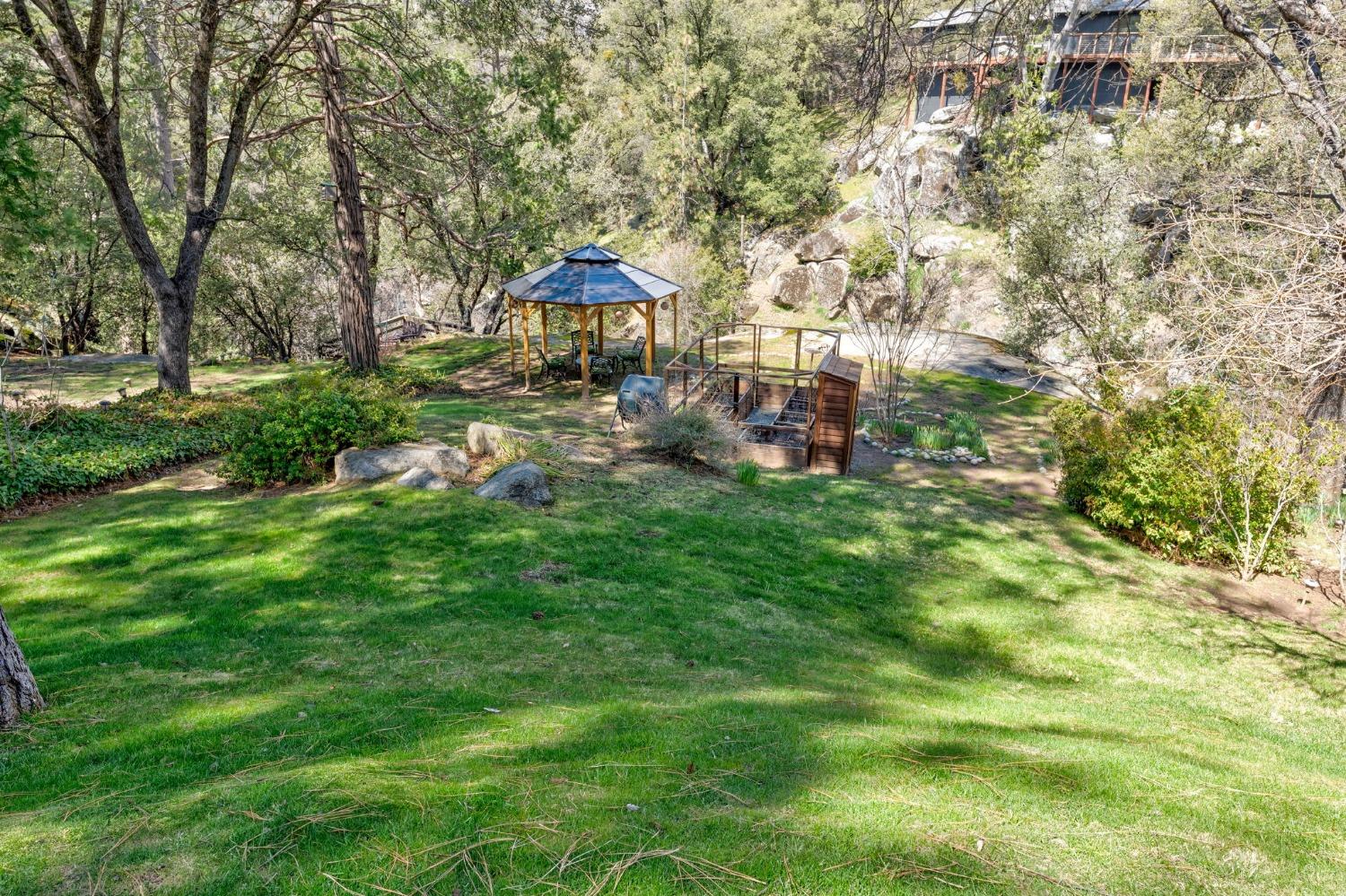 42538 Buckeye Road Oakhurst, CA 93644 - Photo 37 of 46 a view of a house with backyard and sitting area
