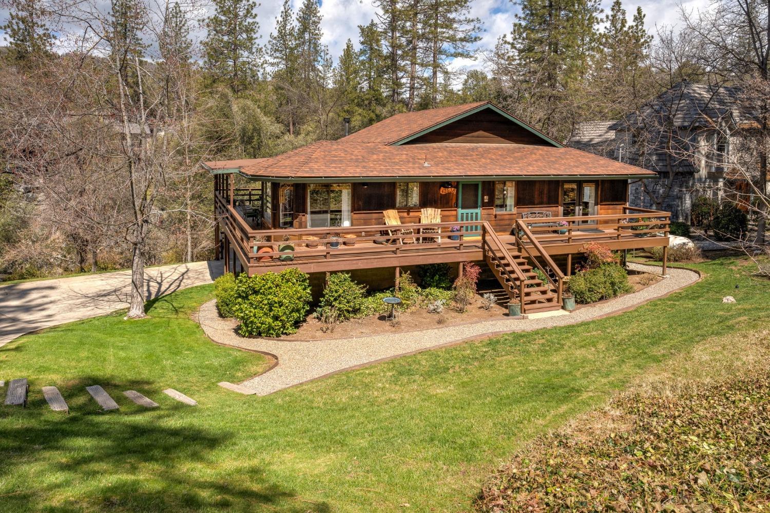 42538 Buckeye Road Oakhurst, CA 93644 - Photo 4 of 46 a front view of a house with yard and green space