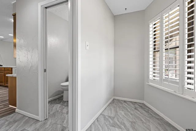 a bathroom with a toilet and a window