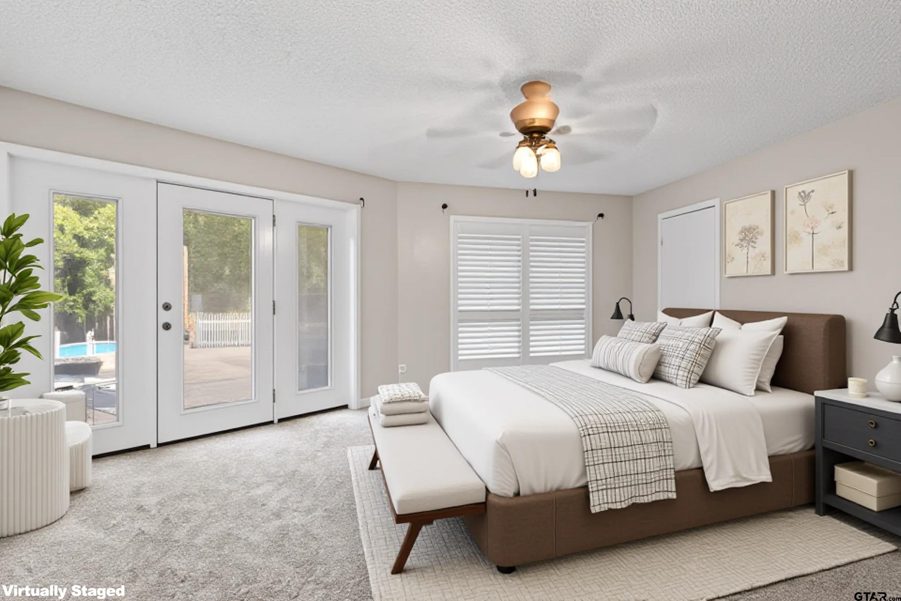 1821 Azalea Street Gilmer, TX 75644 - Photo 13 of 35 a bedroom with a large bed and a chandelier