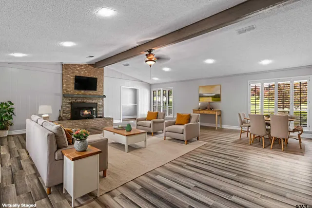 a living room with fireplace furniture and a flat screen tv