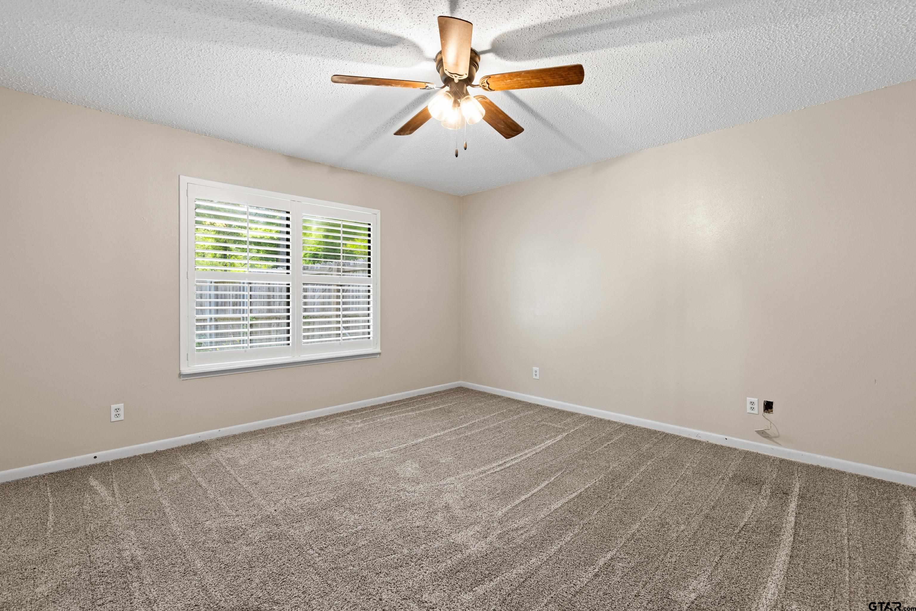1821 Azalea Street Gilmer, TX 75644 - Photo 21 of 35 wooden floor in an empty room with a window