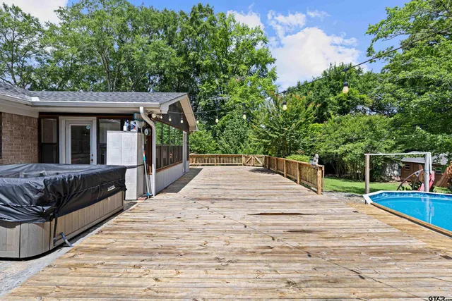 a view of a roof deck with couches and wooden floor