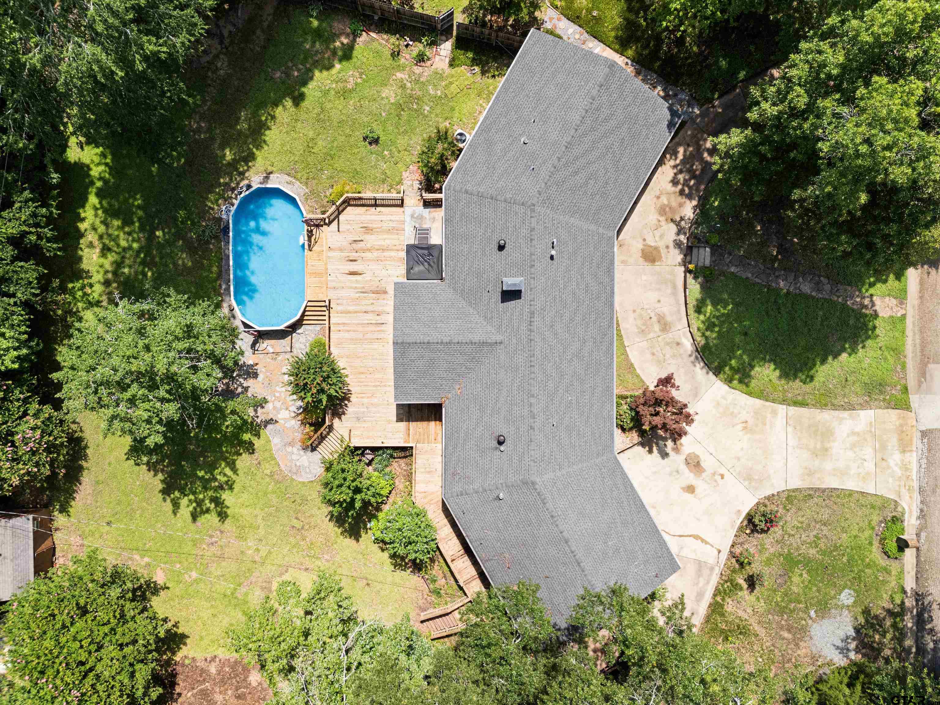 1821 Azalea Street Gilmer, TX 75644 - Photo 29 of 35 an aerial view of a house with a swimming pool and garden