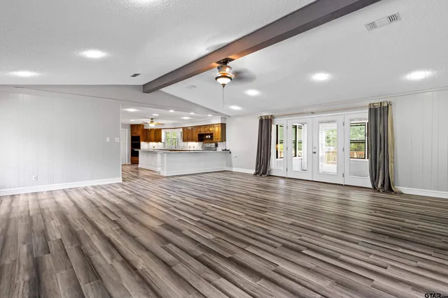 a view of a room with wooden floor