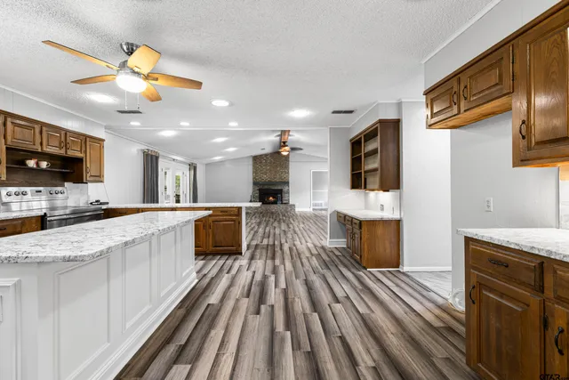 a view of kitchen with sink microwave refrigerator and stove top oven