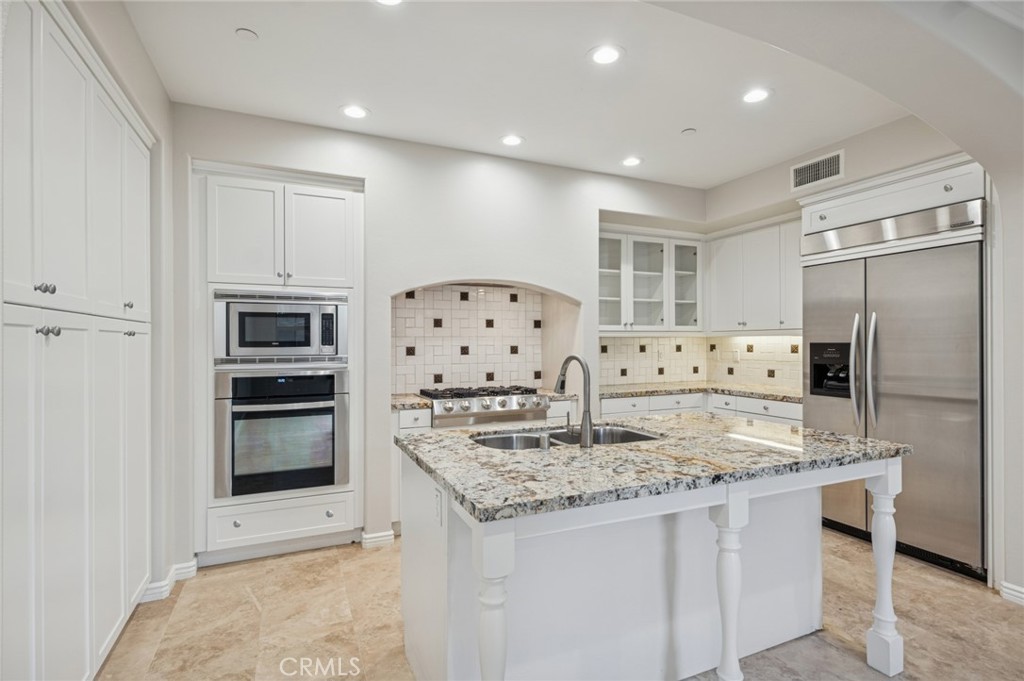 22 Ridge Valley Irvine, CA 92618 - Photo 12 of 37 a kitchen with stainless steel appliances granite countertop a refrigerator and a stove top oven